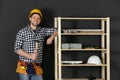 Handsome working man in hard hat with hammer. Home repair