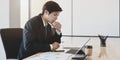 Handsome young accountant preparing special financial reports with tablet