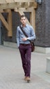 Handsome Young Adult Male Walking With A Messenger Bag