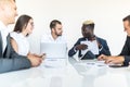 Handsome young african american businessman presenting figures at a meeting with team. Team work Royalty Free Stock Photo