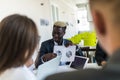 Handsome young african american businessman presenting figures at a meeting with team. Team work Royalty Free Stock Photo