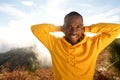 Handsome young african american man smiling with hands behind head outdoors Royalty Free Stock Photo