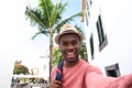 Handsome young african american man smiling while taking selfie on vacation Royalty Free Stock Photo