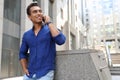 Handsome young African-American man talking on mobile phone. Space for text Royalty Free Stock Photo