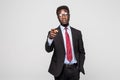 Handsome young African man in formalwear pointing on you while standing against grey background Royalty Free Stock Photo