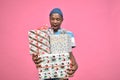 handsome young african man holding a lot of presents and looking very excited Royalty Free Stock Photo