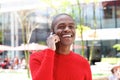 Handsome young african man laughing with cell phone Royalty Free Stock Photo