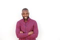 Handsome young african man smiling with arms crossed by white wall Royalty Free Stock Photo