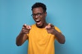 Handsome young african man in yellow clothes pointing his finger at you Royalty Free Stock Photo