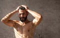 Handsome young Arabic male model taking hot shower Royalty Free Stock Photo