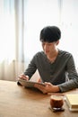 Handsome young Asian man using digital tablet in the cafe Royalty Free Stock Photo