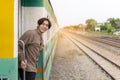 Handsome Young Asian man hand to say hello or goodbye to friend on train, Waving Goodbye Royalty Free Stock Photo