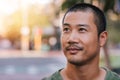 Handsome young Asian man standing on a city street Royalty Free Stock Photo