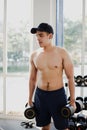 Handsome young asian muscular man in a fitness gym