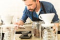 Barista carefully weighing coffee grains