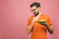 Handsome young man refusing unhealthy burger isolated over pink background. Diet concept. With copy space for text Royalty Free Stock Photo