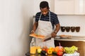 African man preparing healthy food at home in kitchen Royalty Free Stock Photo