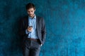 Handsome young bearded business man in office using mobile phone indoors. Royalty Free Stock Photo