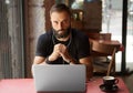 Handsome Young Bearded Businessman Wearing Black Tshirt Working Laptop Urban Cafe.Man Sitting Wood Table Cup Coffee Royalty Free Stock Photo