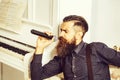 Bearded man sings in microphone