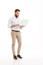 Handsome young bearded man using laptop. Royalty Free Stock Photo