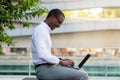 Handsome Young Black Businessman Working On Laptop Computer Outdoors Royalty Free Stock Photo
