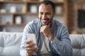 Handsome Young Black Man Looking At Smartphone In His Hand And Smiling Royalty Free Stock Photo