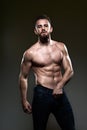 Handsome young body builder, on grey background Royalty Free Stock Photo