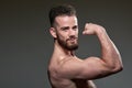Handsome young body builder, on grey background Royalty Free Stock Photo