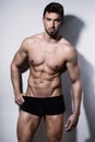 Handsome young bodybuilder showing of his fit body