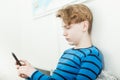 Handsome young boy checking his mobile phone Royalty Free Stock Photo