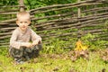 Handsome young boy squatting alongside a fire Royalty Free Stock Photo