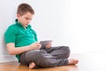 Handsome Young Boy with Tablet Leaning on Wall Royalty Free Stock Photo