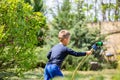 Young boy watering garden with rubber hosepipe Royalty Free Stock Photo