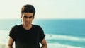 Handsome young brazilian guy with ocean in background