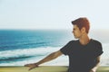 Handsome young brazilian guy with ocean in background