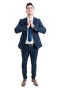 Handsome young broker or salesman standing and praying