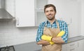 Handsome Young Brunet in Household Gauntlets and Apron Posing