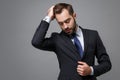 Handsome young business man in classic black suit shirt tie posing isolated on grey background in studio. Achievement Royalty Free Stock Photo