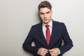 Handsome young business man closing his jacket Royalty Free Stock Photo