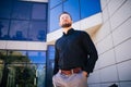 Bearded handsome young business man at office building outdoors Royalty Free Stock Photo