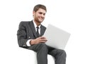 Handsome young business man sitting on a white modern chair Royalty Free Stock Photo