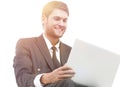 Handsome young business man sitting on a white modern chair Royalty Free Stock Photo