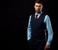 Handsome young business man standing on black Royalty Free Stock Photo