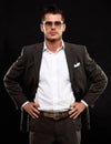 Handsome young business man standing on black Royalty Free Stock Photo