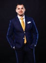 Handsome young business man standing on black Royalty Free Stock Photo