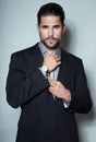 Handsome young business man in suit on grey background