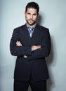 Handsome young business man in suit on grey background Royalty Free Stock Photo