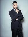 Handsome young business man in suit on grey background Royalty Free Stock Photo