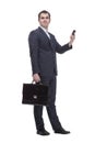 handsome young business man talking on a mobile phone and holding a suitcase on white background Royalty Free Stock Photo